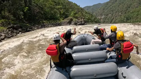 An Adventure Park crew in A.P. helmets paddles into a rapid on the Ganga